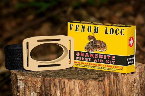 VENOM LOCC snake bite kit displayed on a log