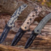 three knives engraved with "snake handler" side by side stuck into log